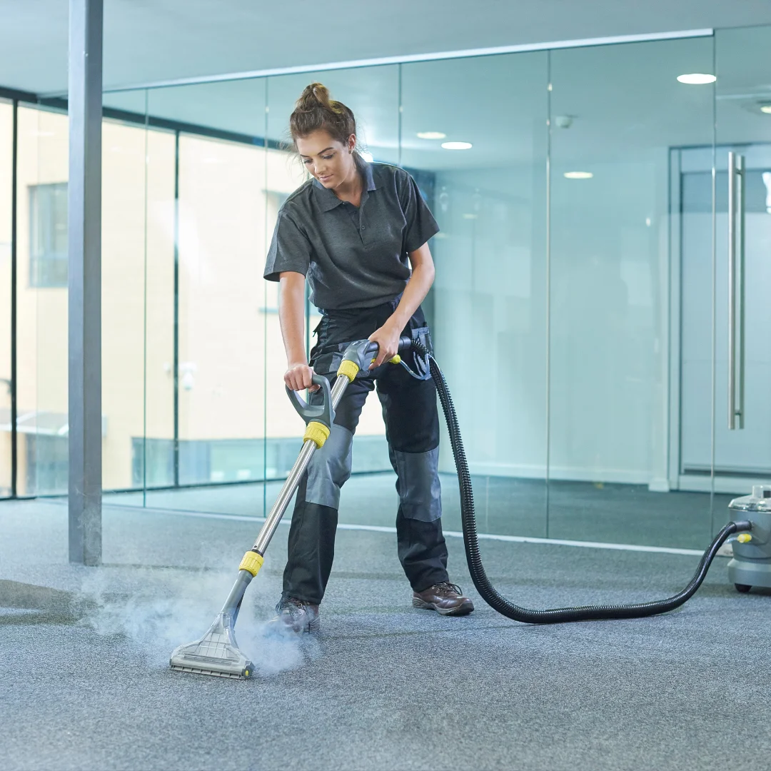 A female employee is seen cleaning a carpet